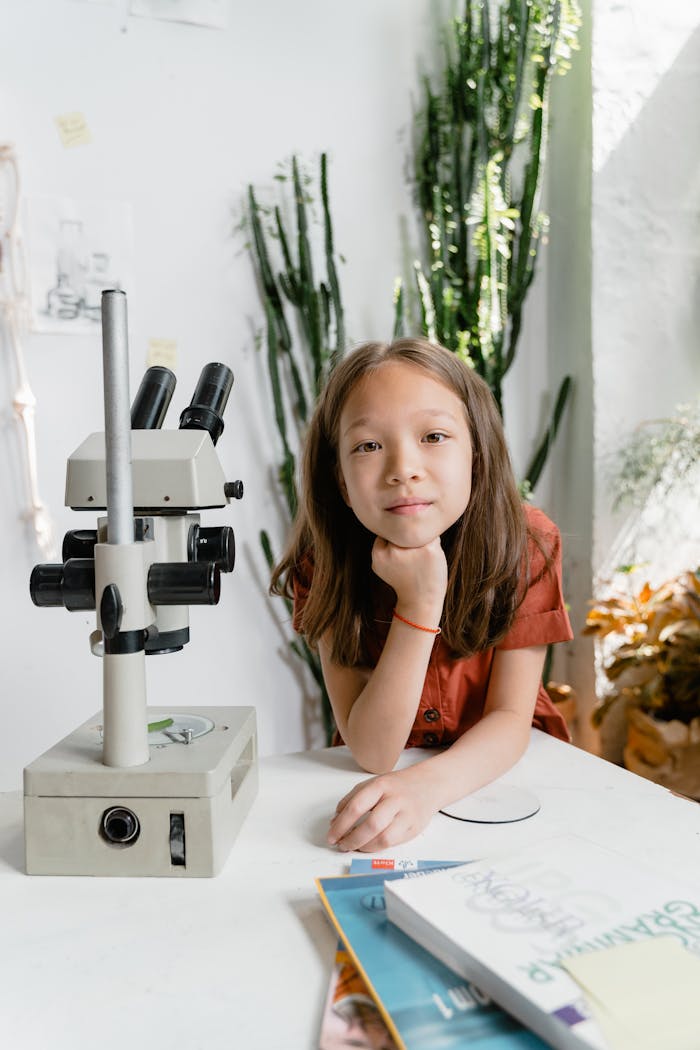 A young girl in a classroom setting, engaging with a microscope. Bright, educational environment.